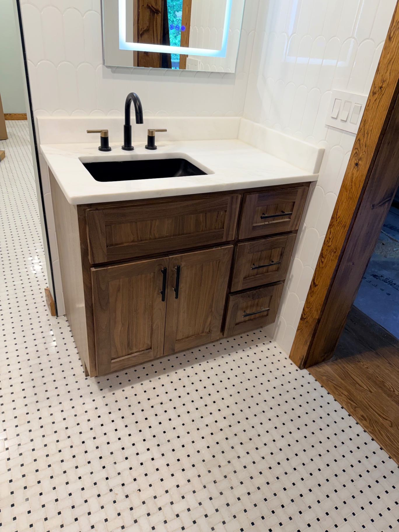 Stained wood vanity with stone top by Customs By Shelton